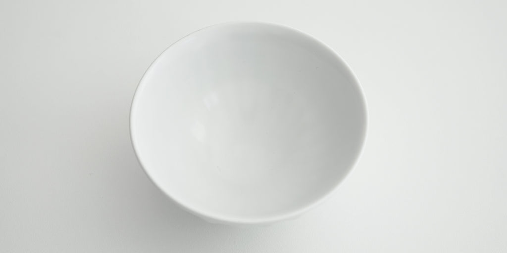 View of the inside of a white stoneware bowl crafted by Xu De Jia.