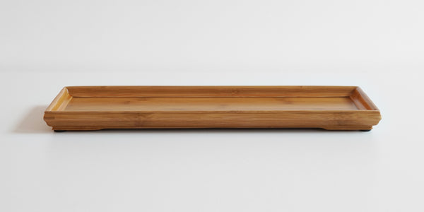 A rectangular bamboo service tray with a slightly raised edge, displayed on a plain background.