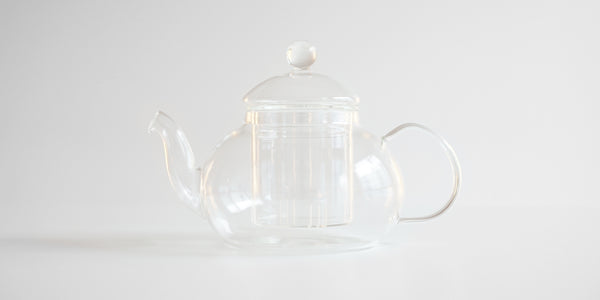 Side view of a glass teapot.