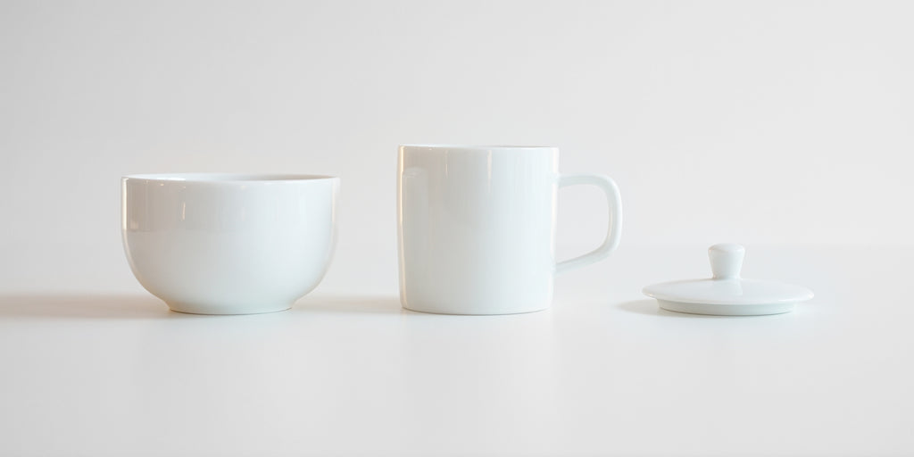 Side view of each piece of the competition brewing set. From left to right, the bowl, the brewing cup, and the lid.