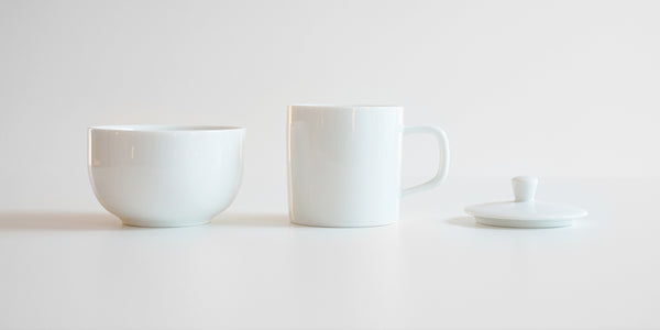 Side view of each piece of the competition brewing set. From left to right, the bowl, the brewing cup, and the lid.