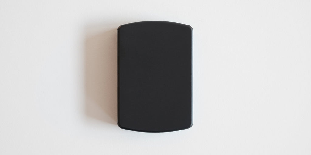 A matte black scale on a white background. The lid is on, covering everything up.