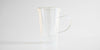 Side view of the glass infuser cup. The infuser is in the cup, and the lid covers it.
