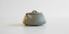 Front view of a gray duanni yixing teapot, showing its short spout.