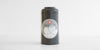 Front view of a gray metal canister, with a Red Blossom Tea Company logo in the middle.