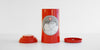 Red tea canister with a Red Blossom Tea Company graphic on the front, with the inner and outer lids placed on either side.