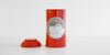 Red tea canister with a Red Blossom Tea Company graphic on the front, with the outer lid placed next to it.