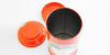 Top-down view of the inside of a red metal canister, with the inner and outer lids in the background.