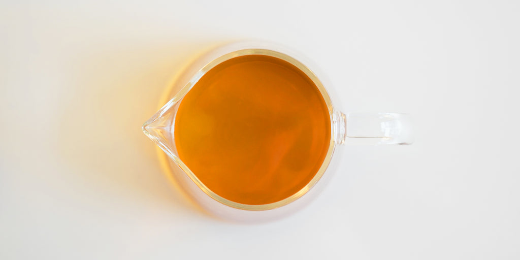 Top down view of a glass server with tea in it.
