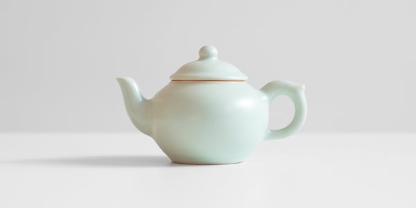 A side-view of a celadon teapot.