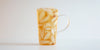 A glass cup filled with ice and black tea on a white background.