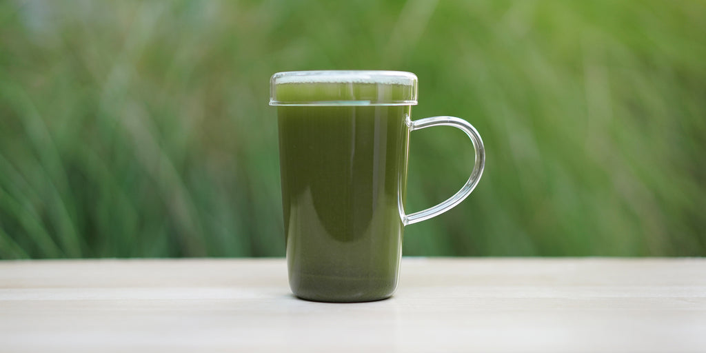 A clear glass mug filled with brewed Lishan Matcha