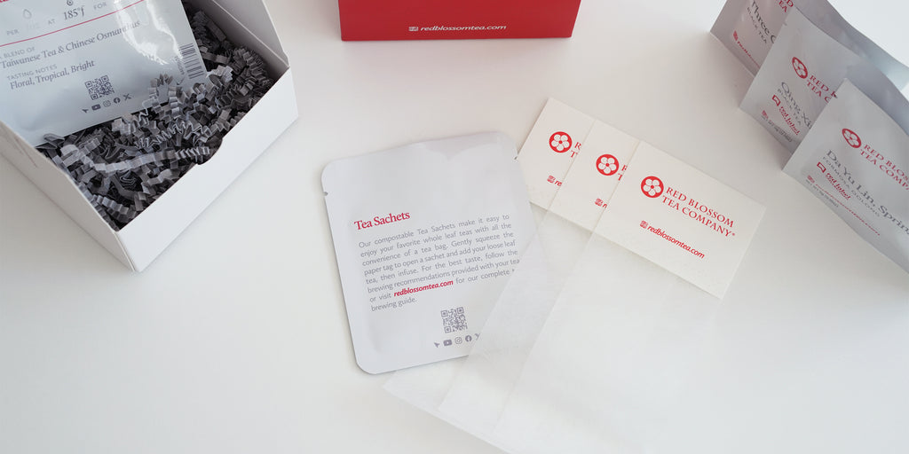 Top-down shot that highlights a pack of empty tea sachets. Packs of loose-leaf tea are on the side, ready to be loaded into the tea sachets.