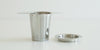 Side view of a steel infuser basket, with wings to hang over the top of a cup. A steel lid is set off to the side.