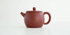 Side view of a terracotta-colored yixing pot, highlighting the oval shape.
