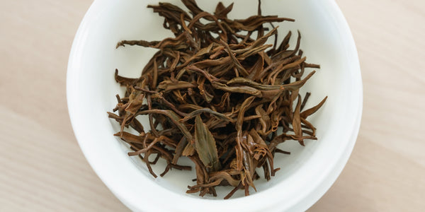 A top-down photo of brewed black tea leaves in a gaiwan.
