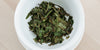 A top-down photo of brewed white tea leaves in a gaiwan.