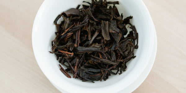 A top-down photo of brewed black tea leaves in a gaiwan.