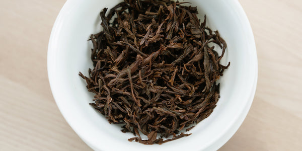 A top-down photo of brewed black tea leaves in a gaiwan.