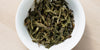 A top-down photo of brewed pu-erh tea leaves in a gaiwan.