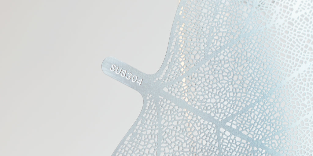Close up of the base of the metal leaf strainer, showing the type of food-grade stainless steel used to make it.