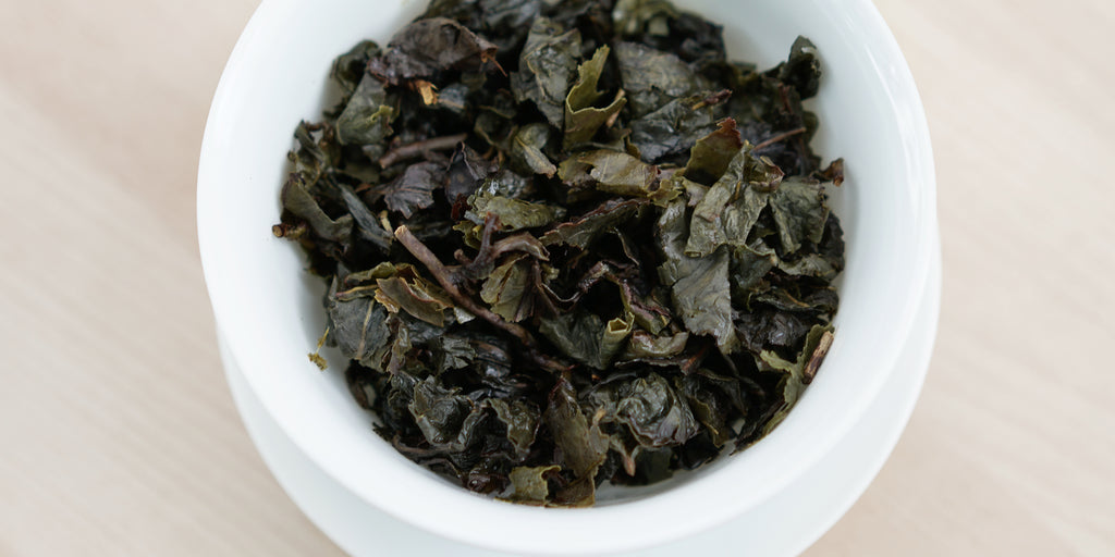 A top-down photo of brewed Tieguanyin tea leaves in a gaiwan.
