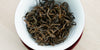 A top-down photo of brewed black tea leaves in a gaiwan.