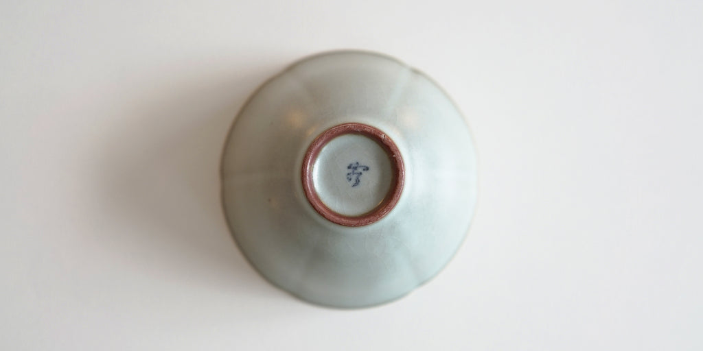 The bottom of a blue-green celadon cup. Xu De Jia's maker's mark is painted on the foot in dark blue.