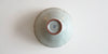 The bottom of a blue-green celadon cup. Xu De Jia's maker's mark is painted on the foot in dark blue.