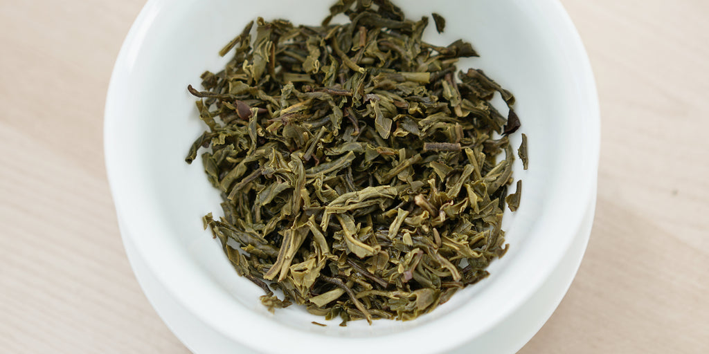 A top-down photo of brewed jasmine tea leaves in a gaiwan.