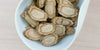 A white dish containing dry slices of ginseng.