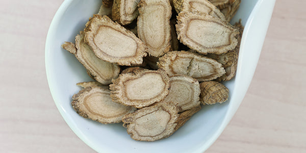 A white dish containing dry slices of ginseng.