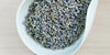 A white dish containing dry lavender.