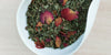 A white dish containing dry peppermint leaves and rose petals.