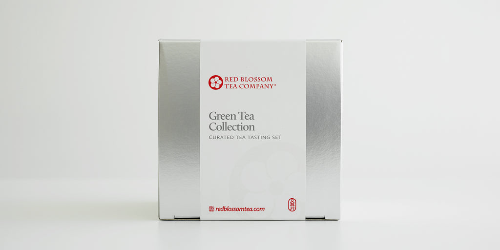 A silver box with a white label reading “Green Tea Collection”
