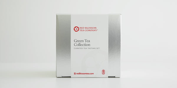 A silver box with a white label reading “Green Tea Collection”