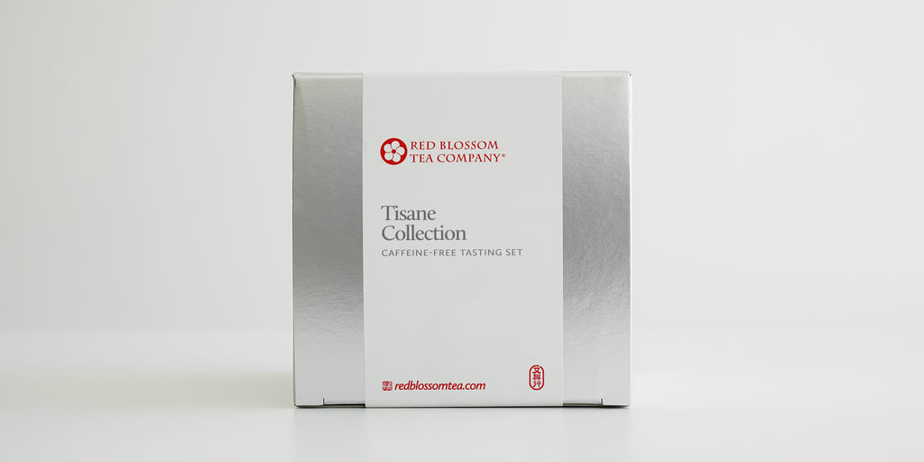 A silver box with a white label reading “Tisane Collection”