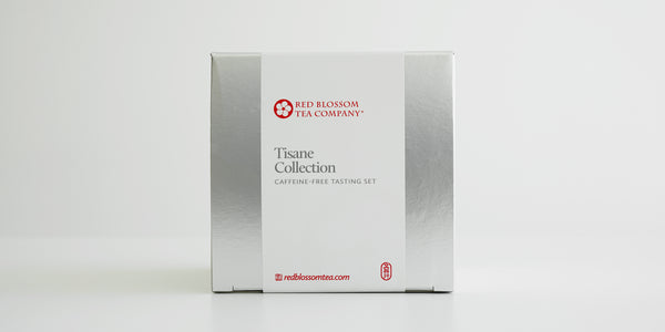 A silver box with a white label reading “Tisane Collection”