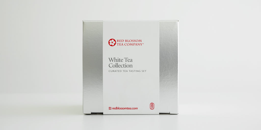 A silver box with a white label reading “White Tea Collection”