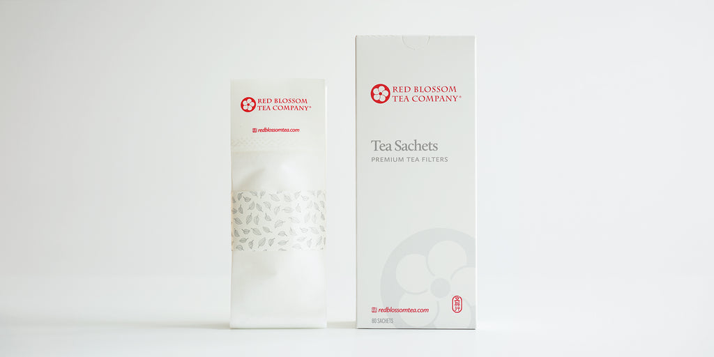 A pack of tea sachets displayed next to the box they come in.