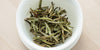 A top-down photo of brewed white tea leaves in a gaiwan.