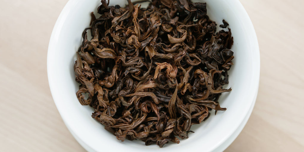 A top-down photo of brewed black tea leaves in a gaiwan.